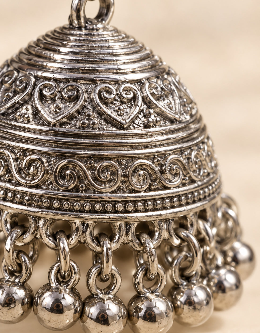 Orneza Silver-Tone Engraved Bell Jhumka Earrings — close-up detail