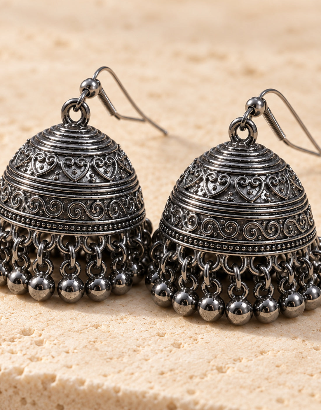 Orneza Dark Oxidised Engraved Bell Jhumka Earrings — angle view