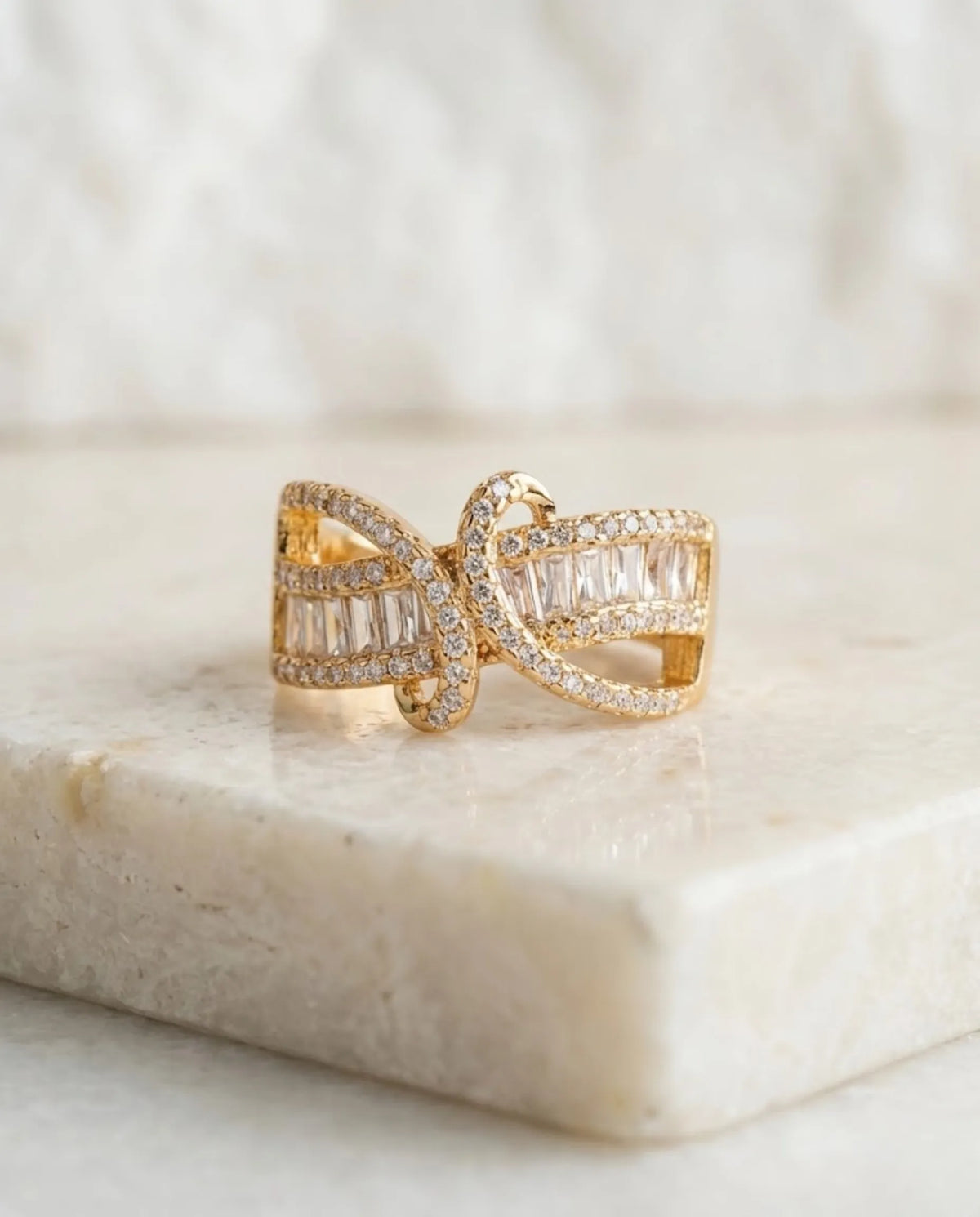Orneza Gilded Bow Baguette Crystal Statement Ring