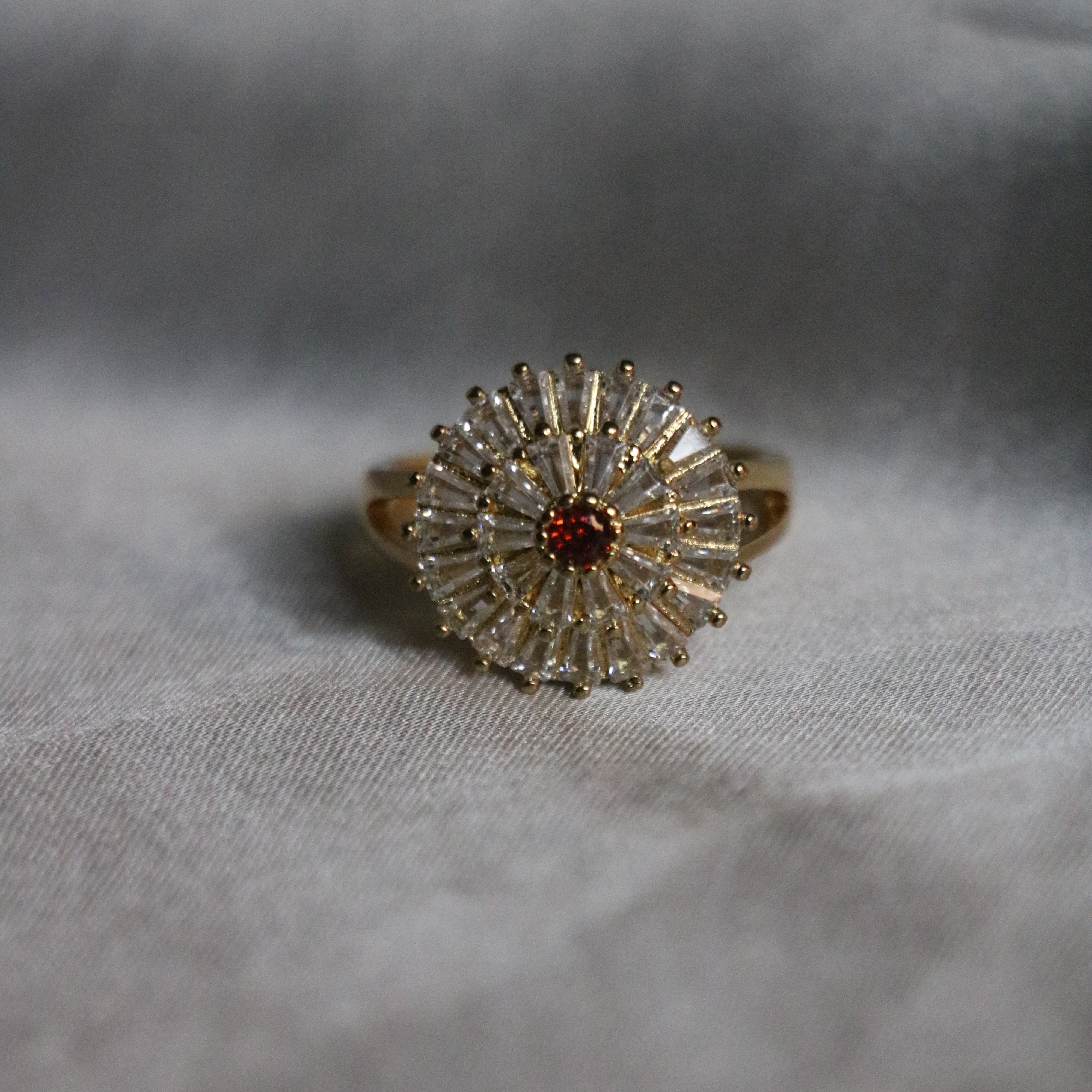 Radiant Gold-Plated Sunburst Ring with Red Center Stone for Women