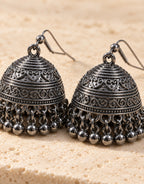 Orneza Dark Oxidised Engraved Bell Jhumka Earrings — angle view