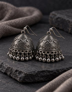 Orneza Dark Oxidised Engraved Bell Jhumka Earrings — styled view