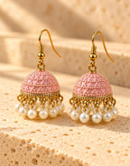 Orneza Pastel Pink Dotted Enamel Jhumka Earrings with Pearls — angle view