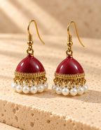 Orneza Maroon Enamel Jhumka Earrings with Pearls — angle view
